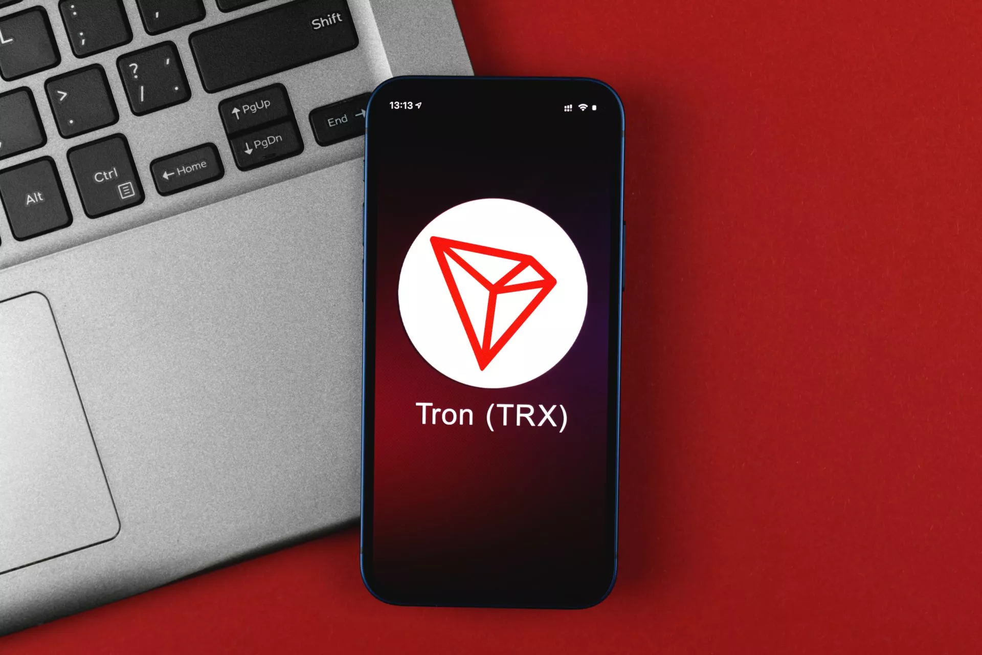 Tron TRX symbol. Trade with cryptocurrency, digital and virtual money, banking with mobile phone concept. Business workspace, table top view