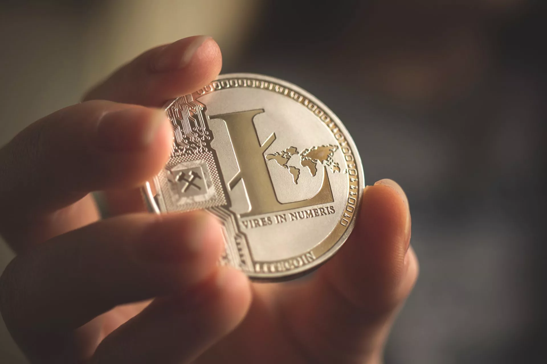 Cryptocurrency Litecoin in hand close-up business background photo