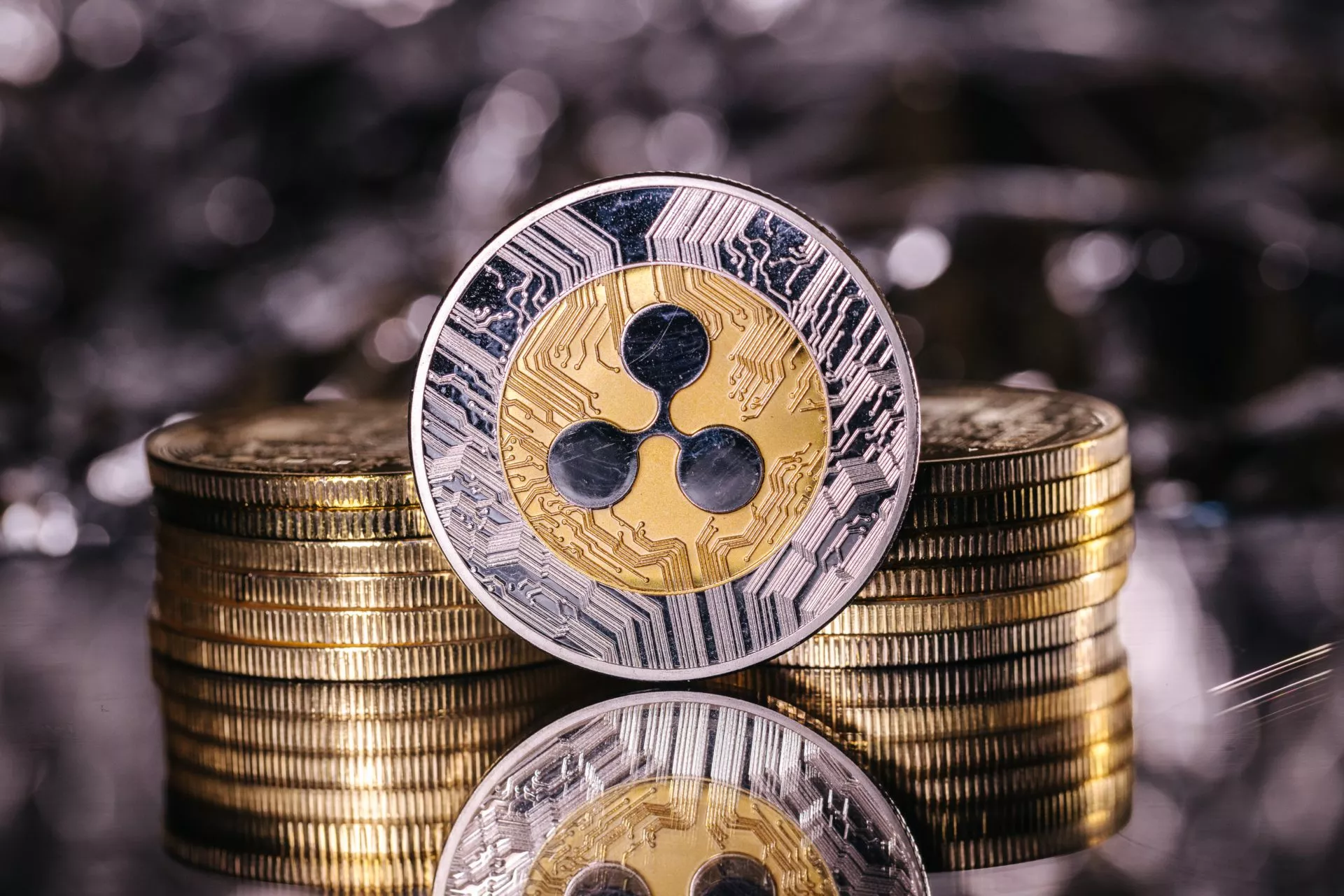 Ripple cryptocurrency, physical coin in front of an abstract bac