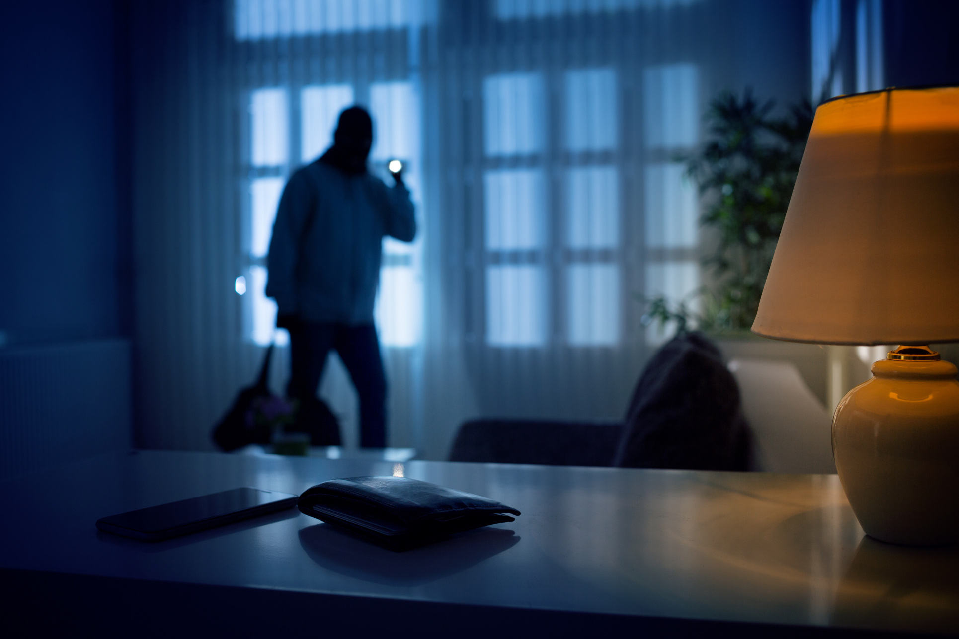 A digital representation of a secure crypto wallet contrasted with a symbolic physical threat representing rising violence against owners.