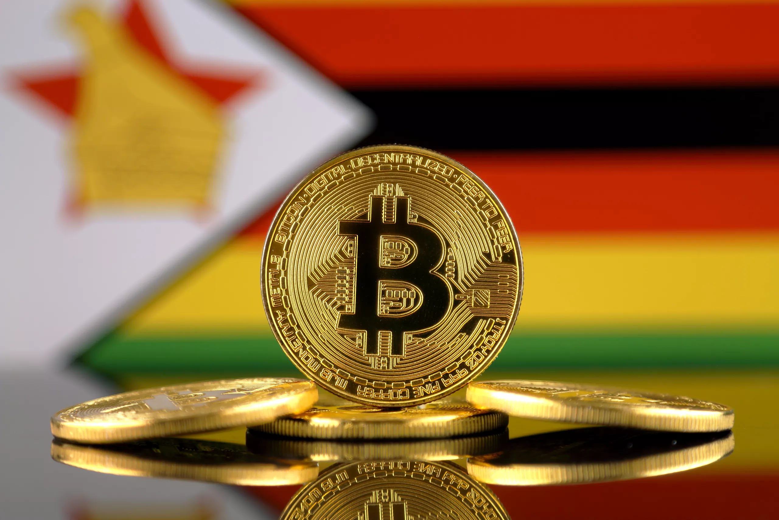 Physical version of Bitcoin (BTC) and Zimbabwe Flag