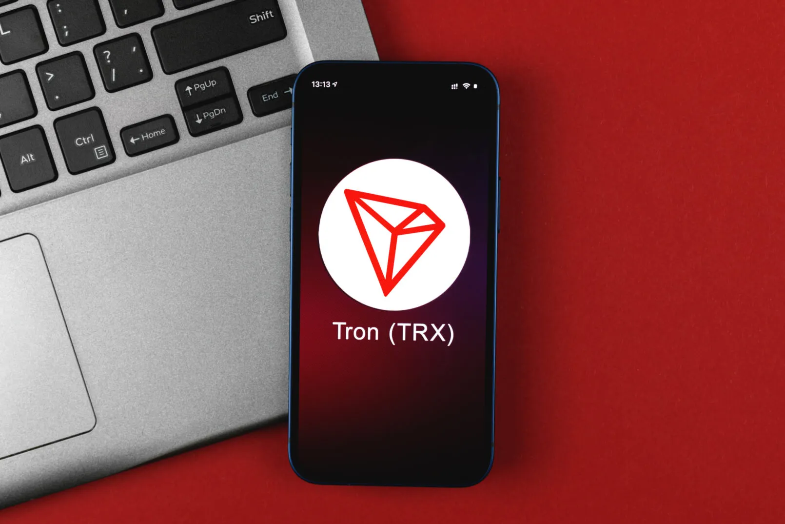 Tron TRX symbol. Trade with cryptocurrency, digital and virtual money, banking with mobile phone concept. Business workspace, table top view